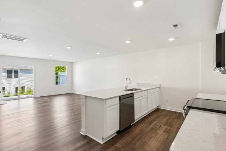 A kitchen with white cabinets.