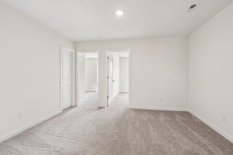 A hallway with white doors.