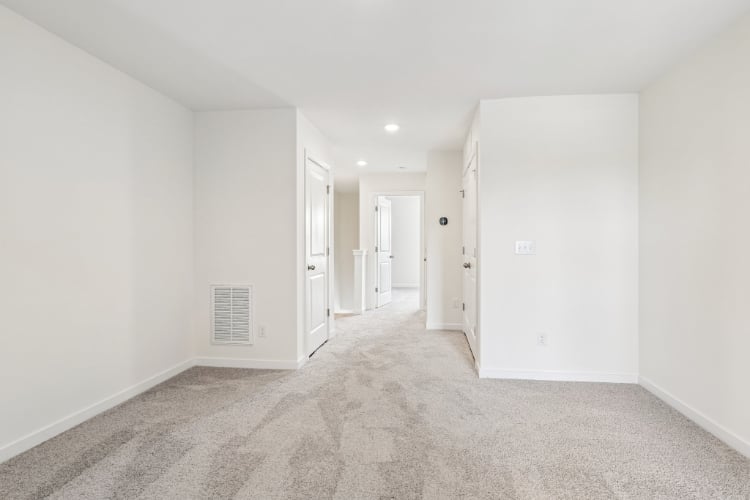 A long hallway with white walls.
