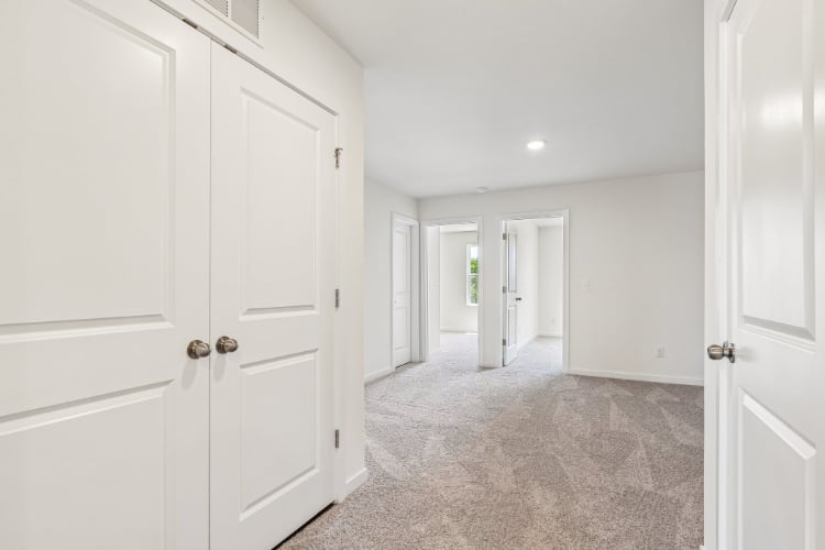A hallway with white doors.