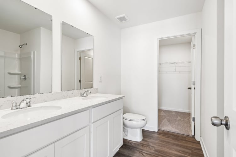 A bathroom with a toilet and sink.