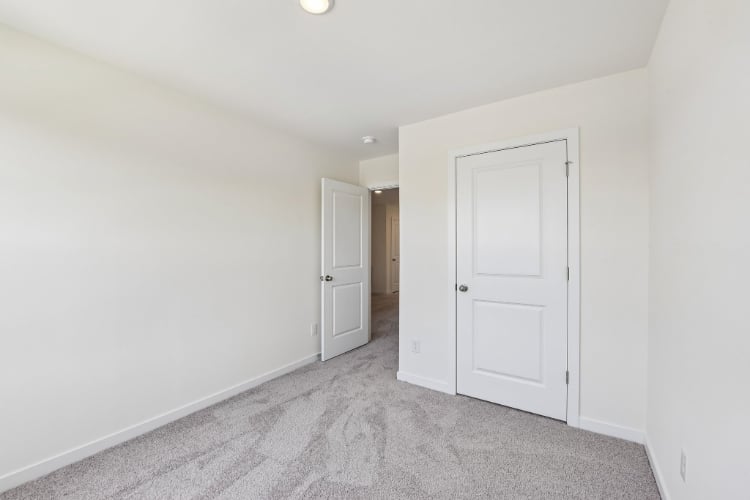 A hallway with white doors.