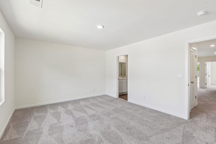 A room with carpet and a door.