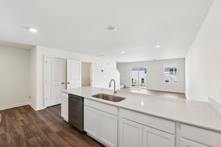 A kitchen with white cabinets.