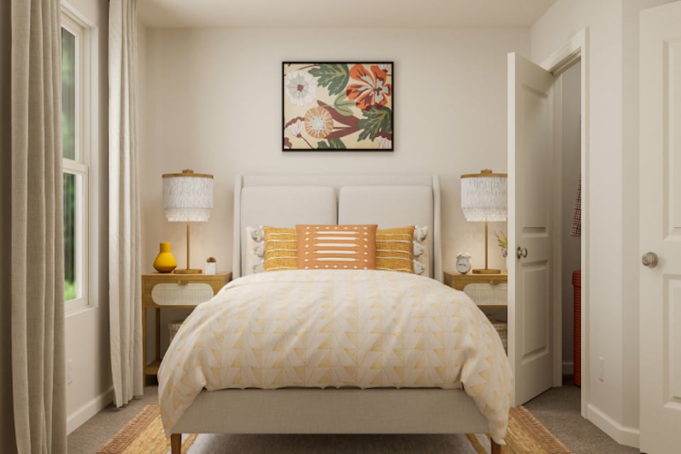 A bedroom with a bed and lamps.