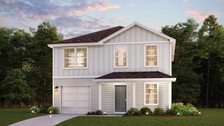 A house with a driveway and trees in the back.