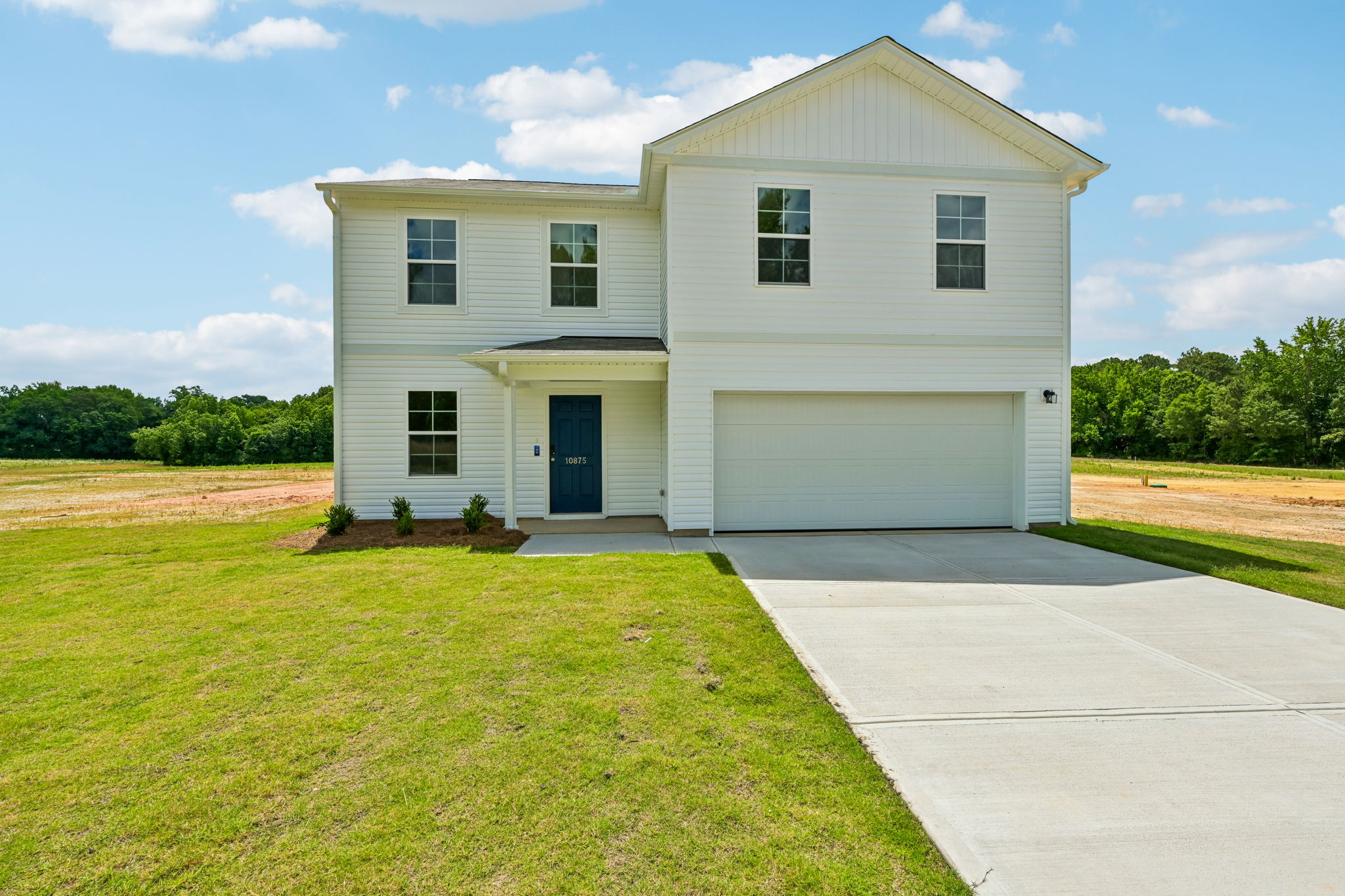 A white house with a garage.