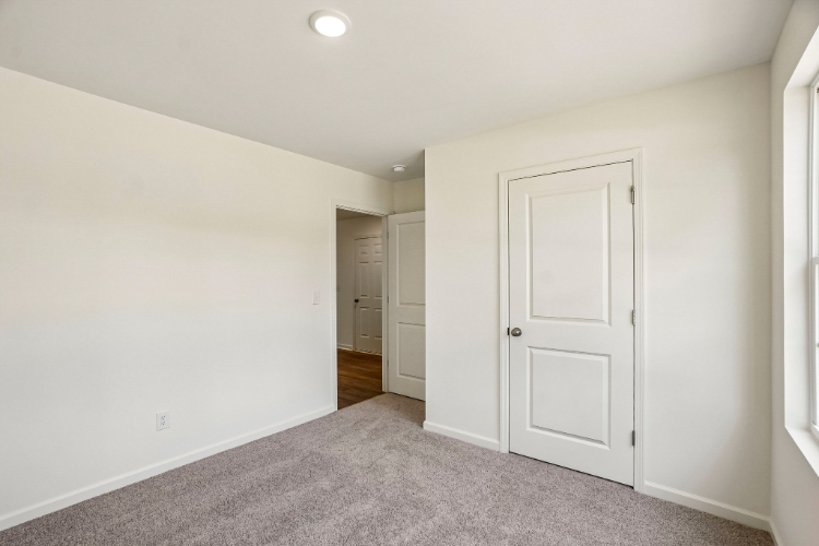 A hallway with white doors.