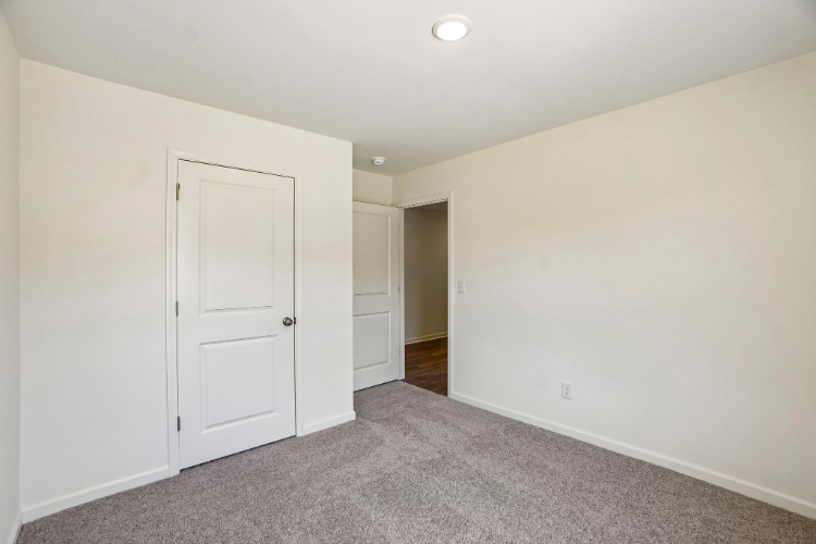 A hallway with white doors.