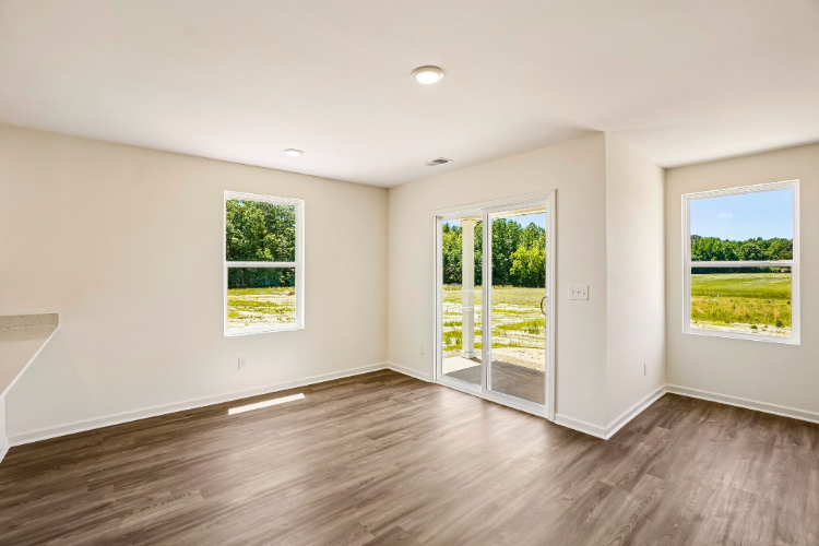 A room with a wood floor and windows.