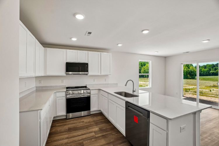 A kitchen with white cabinets.