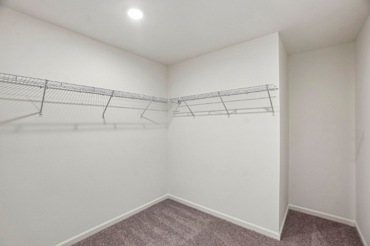 A white room with a metal railing.