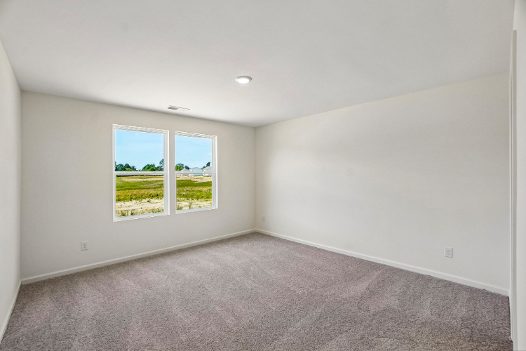 A room with a window and a carpet.