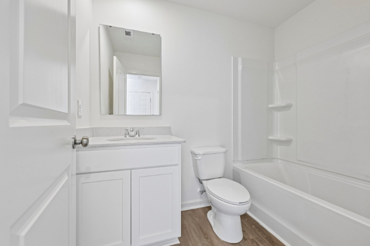 A bathroom with a toilet and bathtub.