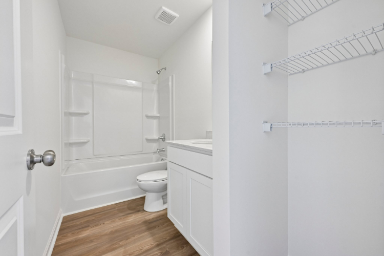 A bathroom with a toilet and bathtub.