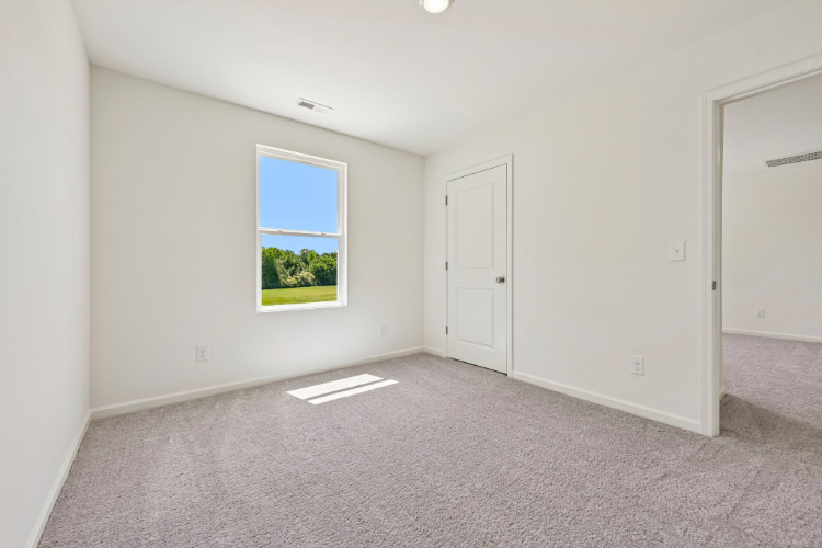 A room with a window and a door.