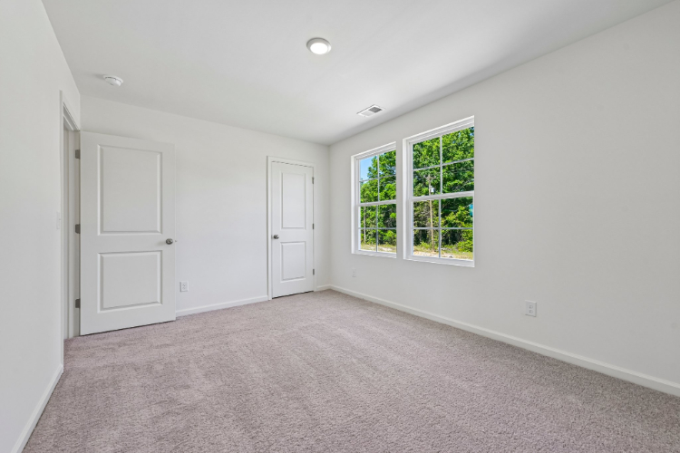 A room with white walls and a window.