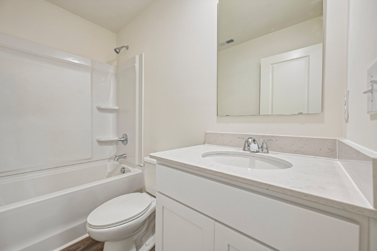 A bathroom with a sink toilet and bathtub.