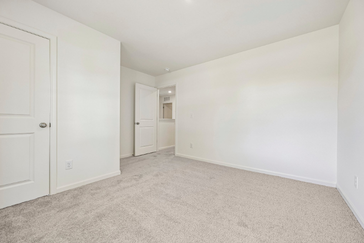 A hallway with white doors.