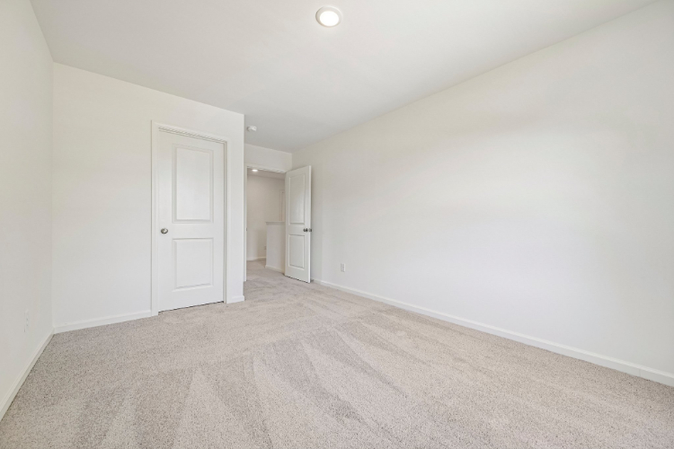 A hallway with white doors.