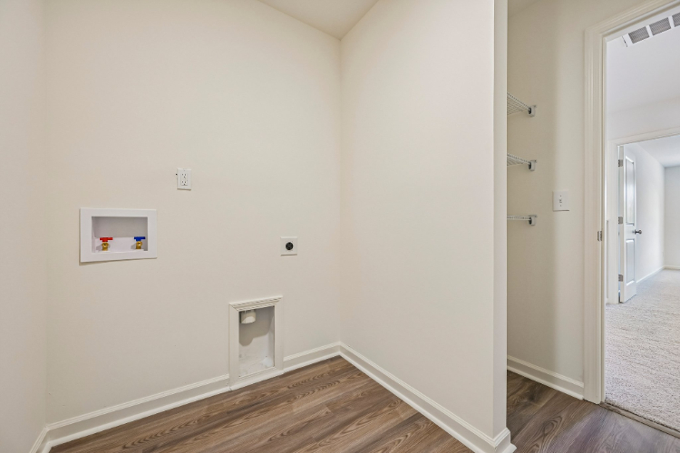 A room with a wood floor and white walls.