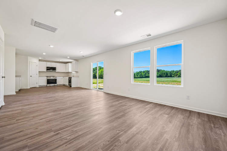A room with white walls and a wood floor.