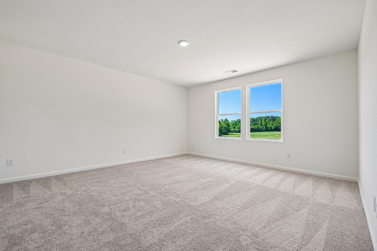 A room with a window and a carpet.