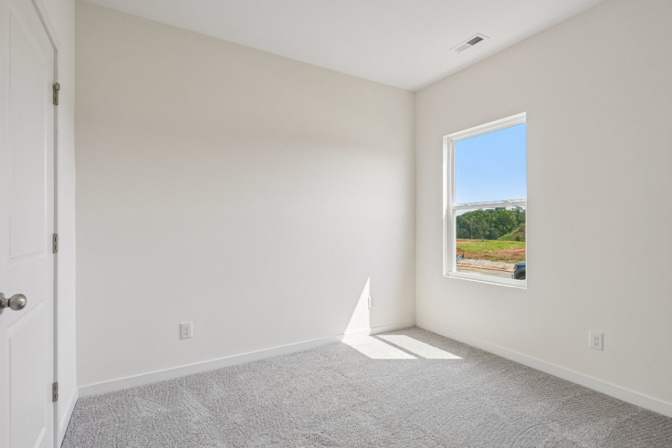 A room with a window and a door.