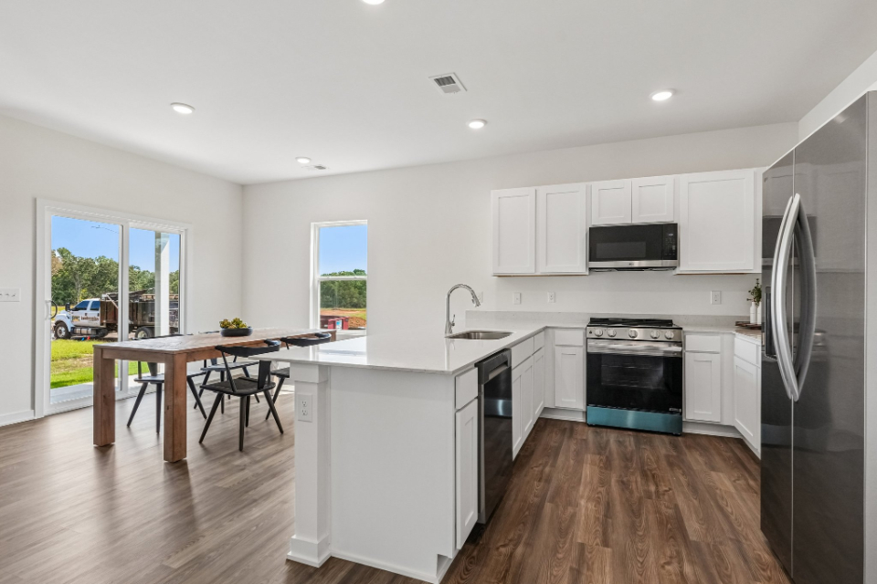 A kitchen with white cabinets.