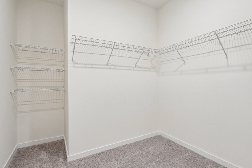 A white wall with a metal railing.
