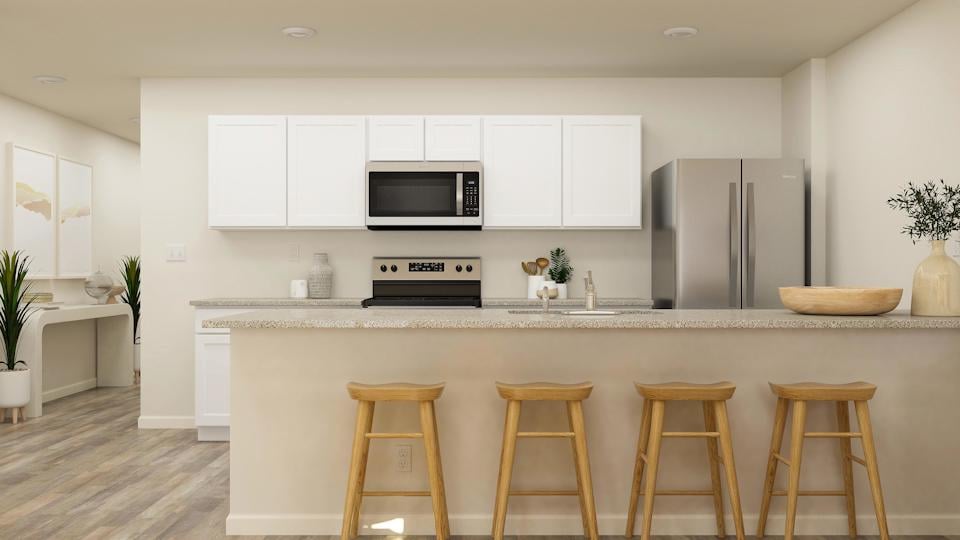 A kitchen with white cabinets.