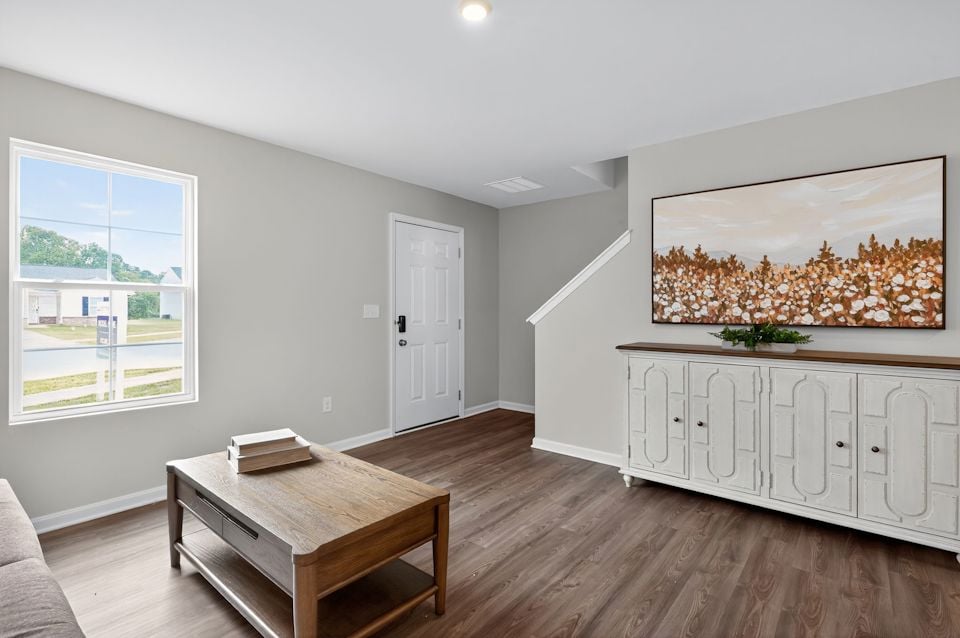 A living room with a wood floor.