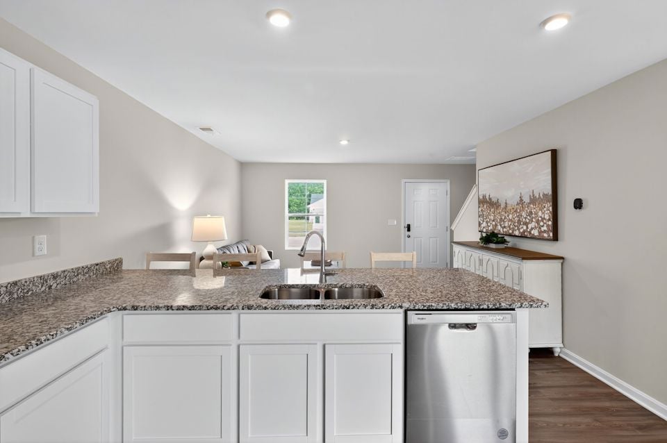 A kitchen with marble counters.