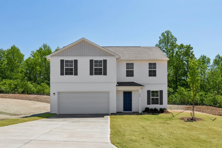 A white house with a garage.