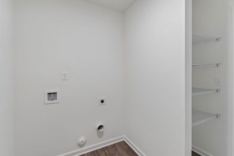 A white wall with a shelf and a white wall.
