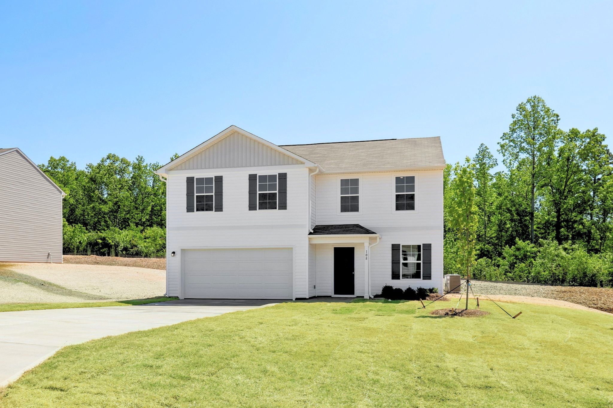 A white house with a garage.