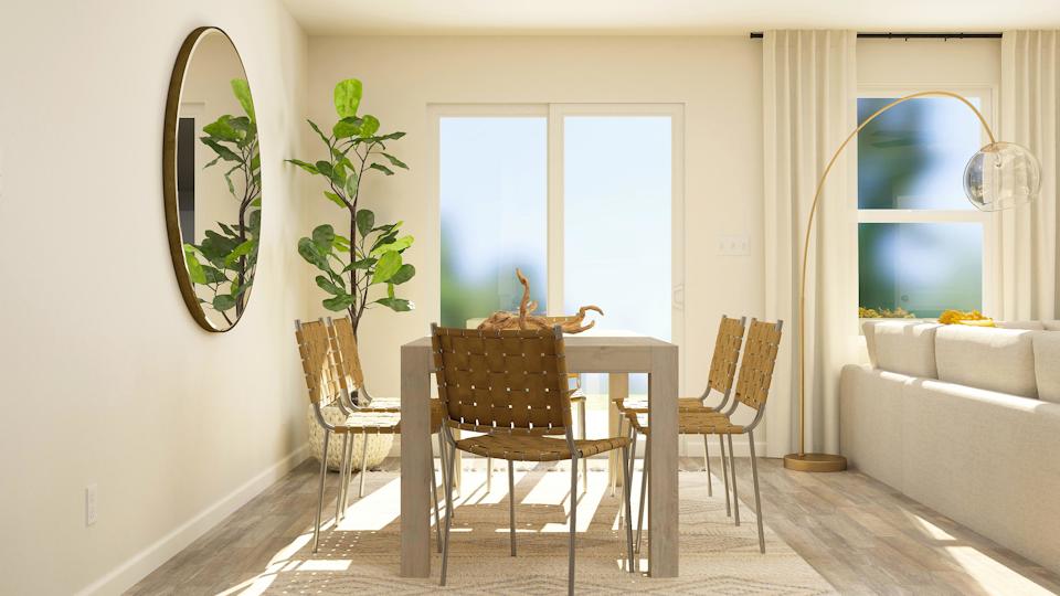A dining room with a table and chairs.