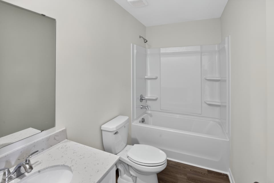A bathroom with a tub toilet and sink.