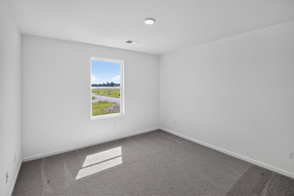 A white room with a large window.