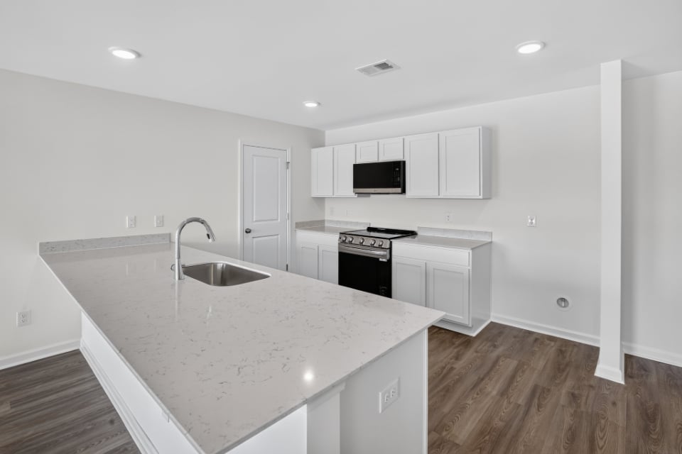 A kitchen with white cabinets.