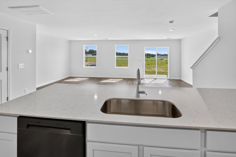 A kitchen with a sink and a window.