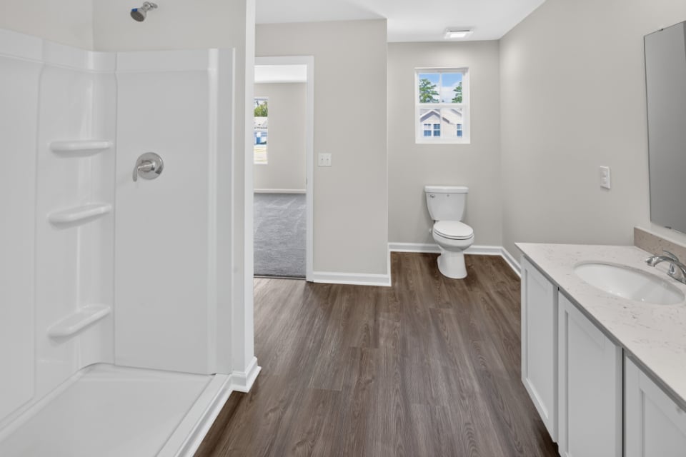 A bathroom with a toilet and sink.