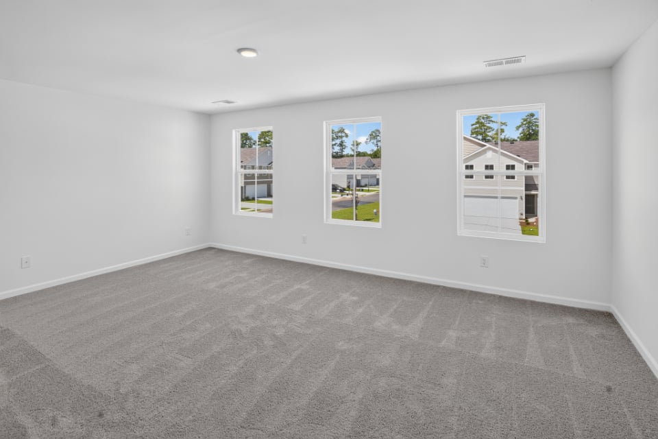 A white room with a few paintings on the wall.
