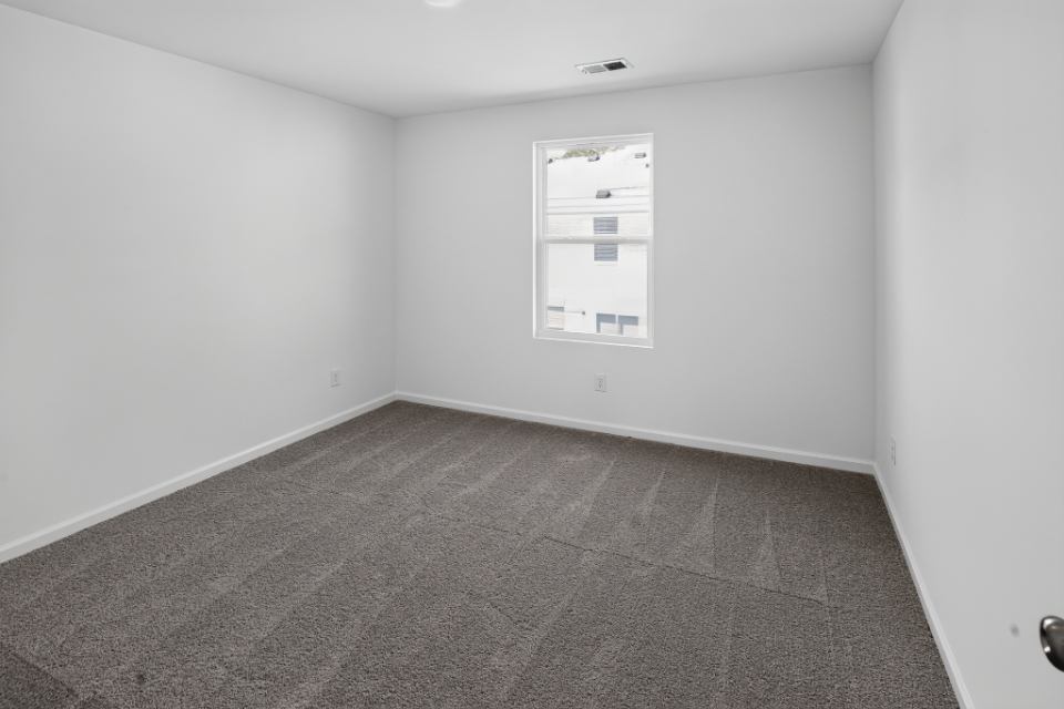A room with a tile floor and a window.