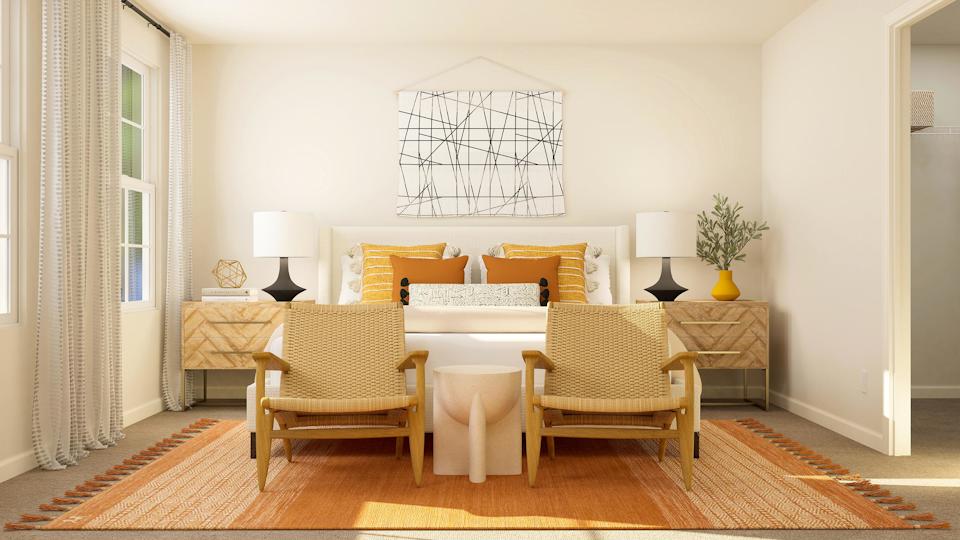 A room with a couch and chairs.