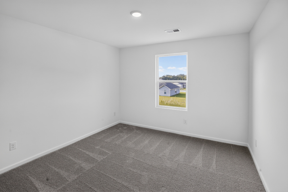 A room with a painting on the wall.