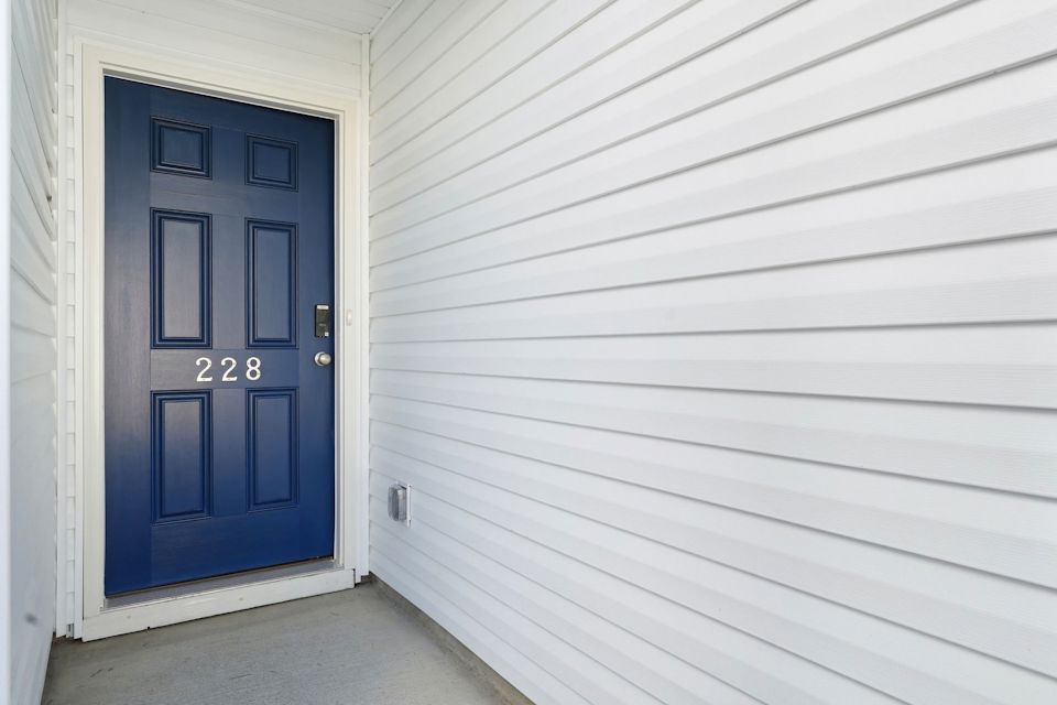A blue door on a white building.