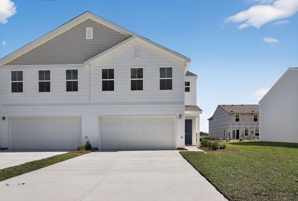 A white house with a driveway.