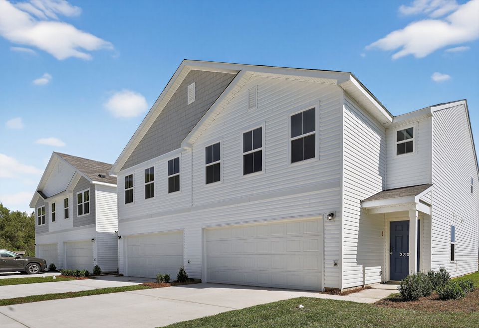 A white house with a garage.