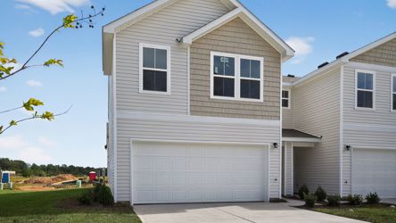 A white house with a garage.